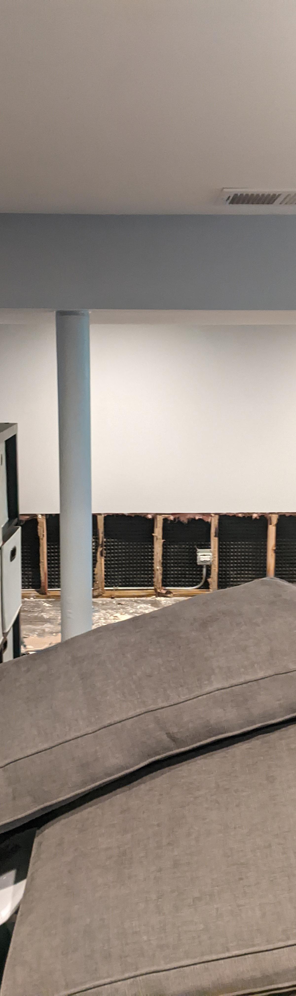 Basement wall opened by flood cuts with exposed studs drying in a Wheaton home
