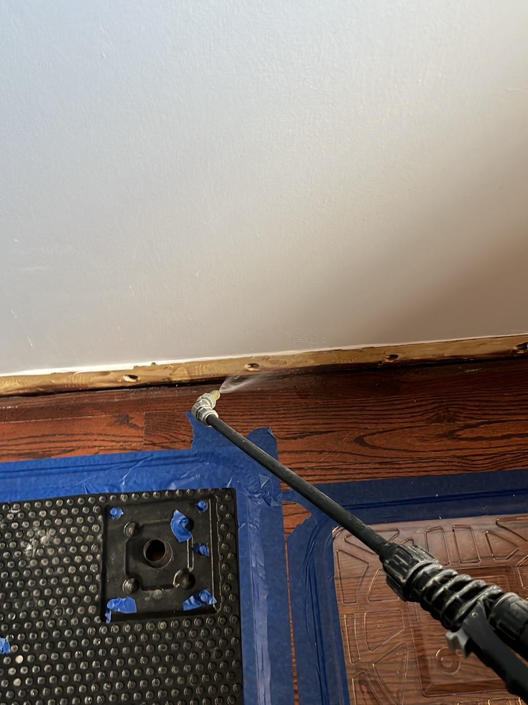 Drying mats and an injection hose set on a hardwood floor in a Darien home