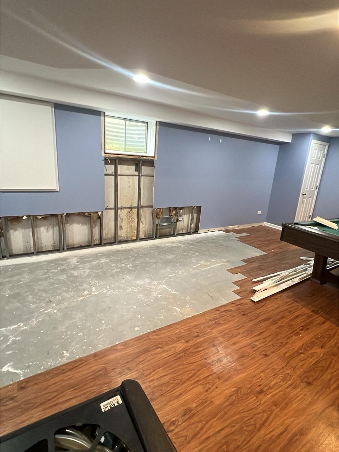 Basement wall opened to the studs after flood cuts in a Naperville home